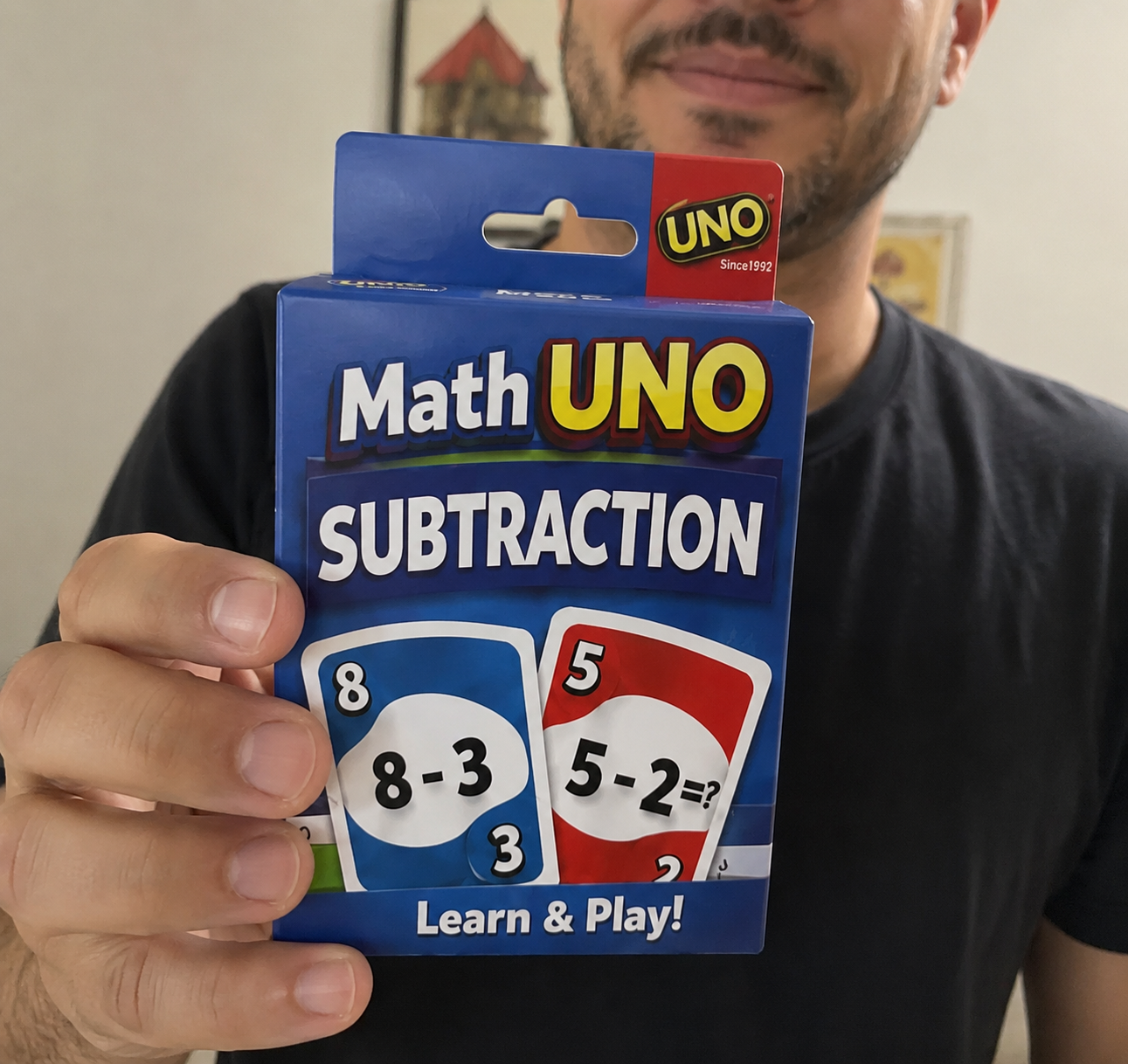 Parent holding the Math UNO Subtraction deck